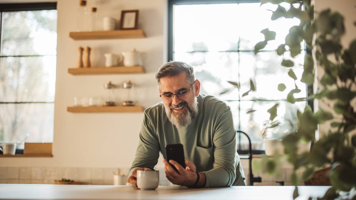 Man smiling at kitchen counter